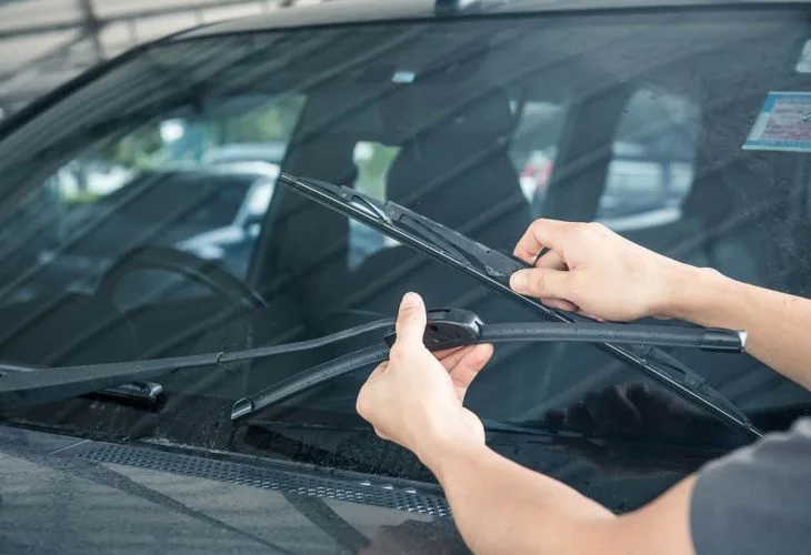 Mechanic replacing a damaged windshield wiper blade
